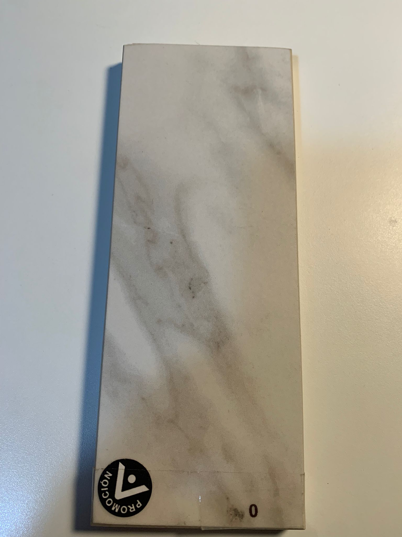 Physical Silestone countertop sample with marble-like white and beige tones
